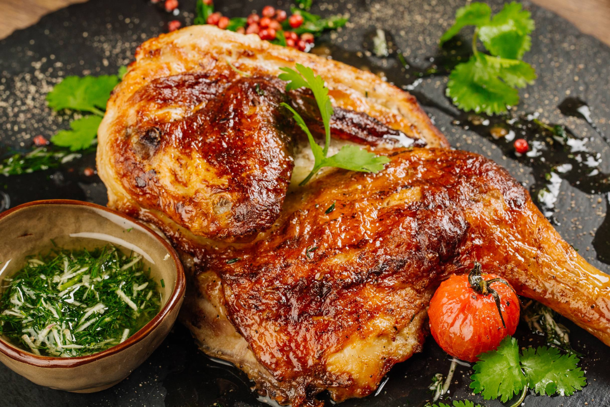 Grilled chicken seasoned with Mac Khen spices on traditional charcoal stove